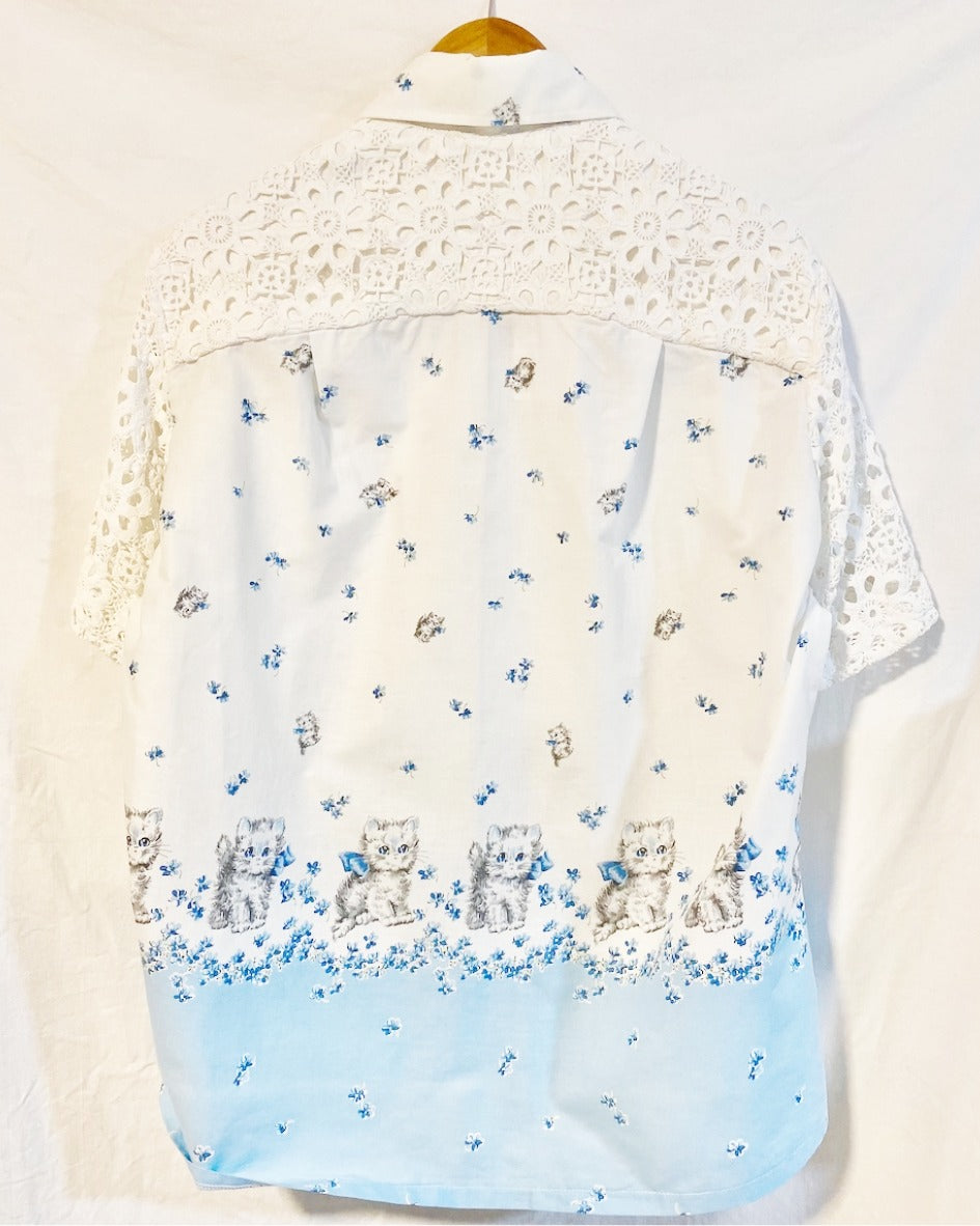 Shirt  with grey kitten and blue floral print on white cotton poplin With white crocheted sleeves and back yoke