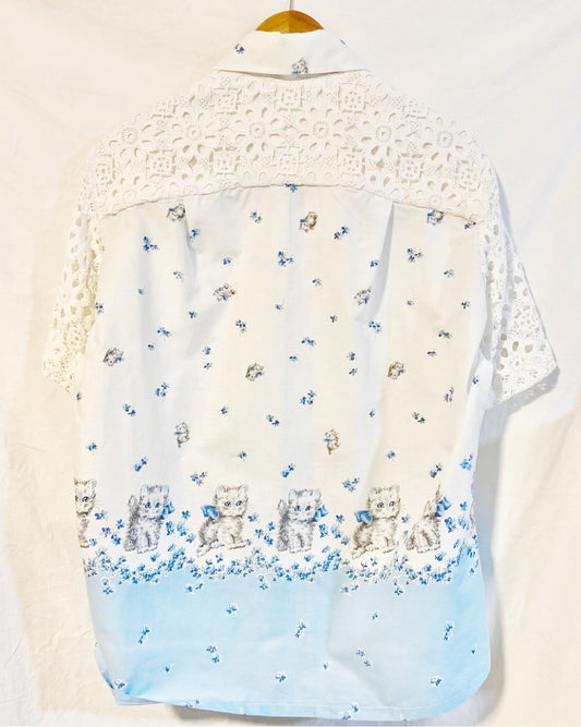 Shirt  with grey kitten and blue floral print on white cotton poplin With white crocheted sleeves and back yoke