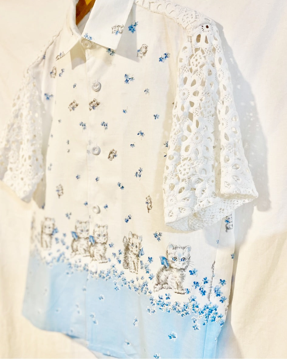 Shirt  with grey kitten and blue floral print on white cotton poplin With white crocheted sleeves and back yoke