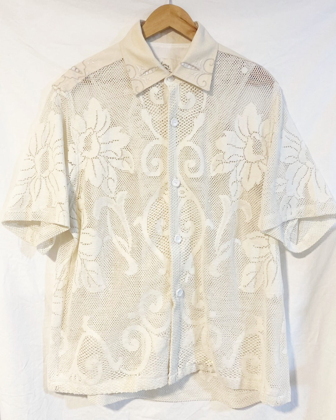 The Ivory shirt is an individually handcrafted unisex piece. It is made from a vintage machine knitted (stretch) cotton lace table cloth and is teamed with a linen embroidered supper cloth for the collar and back yoke