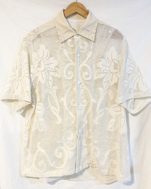 The Ivory shirt is an individually handcrafted unisex piece. It is made from a vintage machine knitted (stretch) cotton lace table cloth and is teamed with a linen embroidered supper cloth for the collar and back yoke