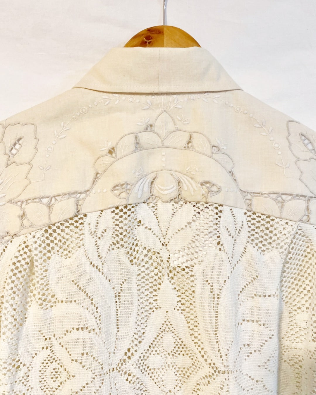 The Ivory shirt is an individually handcrafted unisex piece. It is made from a vintage machine knitted (stretch) cotton lace table cloth and is teamed with a linen embroidered supper cloth for the collar and back yoke