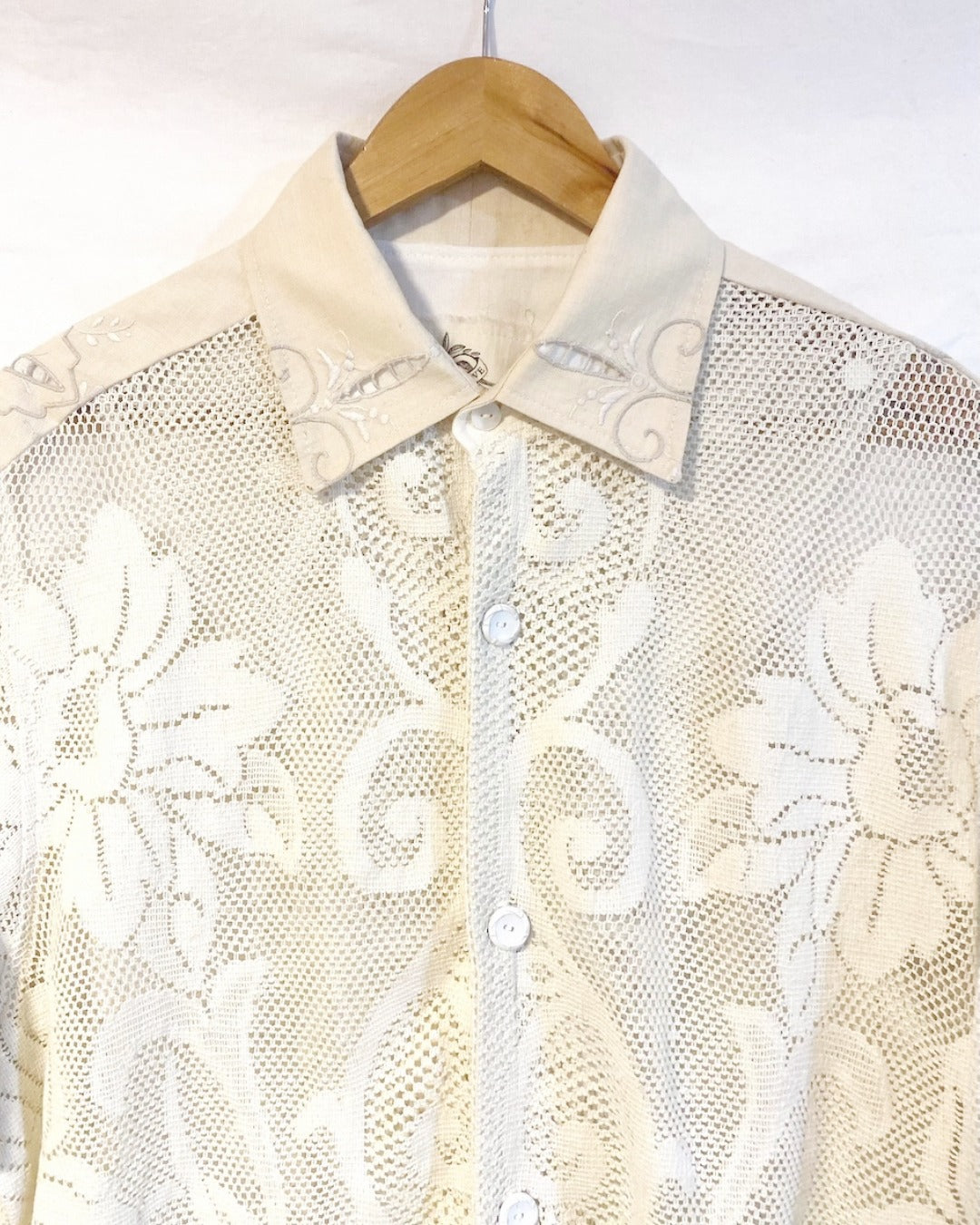 The Ivory shirt is an individually handcrafted unisex piece. It is made from a vintage machine knitted (stretch) cotton lace table cloth and is teamed with a linen embroidered supper cloth for the collar and back yoke