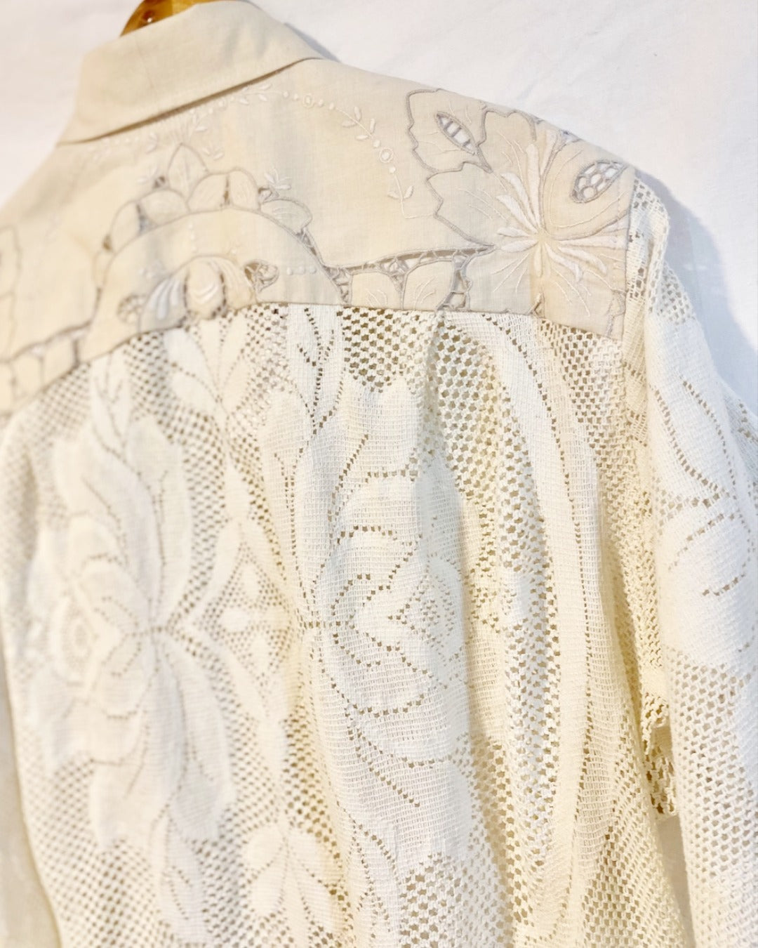 The Ivory shirt is an individually handcrafted unisex piece. It is made from a vintage machine knitted (stretch) cotton lace table cloth and is teamed with a linen embroidered supper cloth for the collar and back yoke
