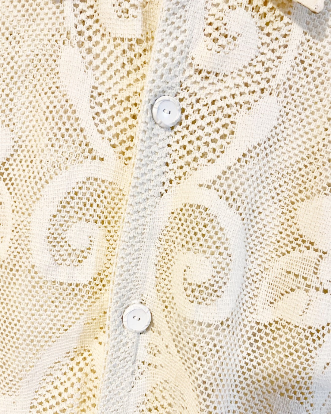 The Ivory shirt is an individually handcrafted unisex piece. It is made from a vintage machine knitted (stretch) cotton lace table cloth and is teamed with a linen embroidered supper cloth for the collar and back yoke