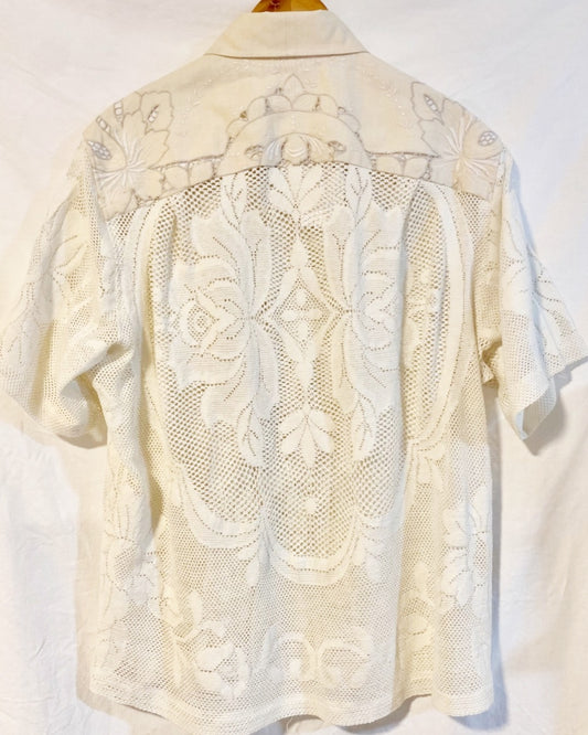 The Ivory shirt is an individually handcrafted unisex piece. It is made from a vintage machine knitted (stretch) cotton lace table cloth and is teamed with a linen embroidered supper cloth for the collar and back yoke